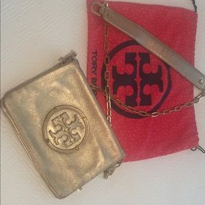 Tory Burch gold crossbody bag with gold hardware.
